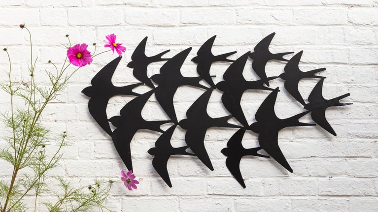 Wall art showing a flock of swallows
